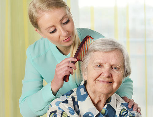 Senior woman with her caregiver in home.